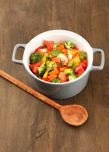 Ragoût de légumes en pot gris sur fond bois — Photo