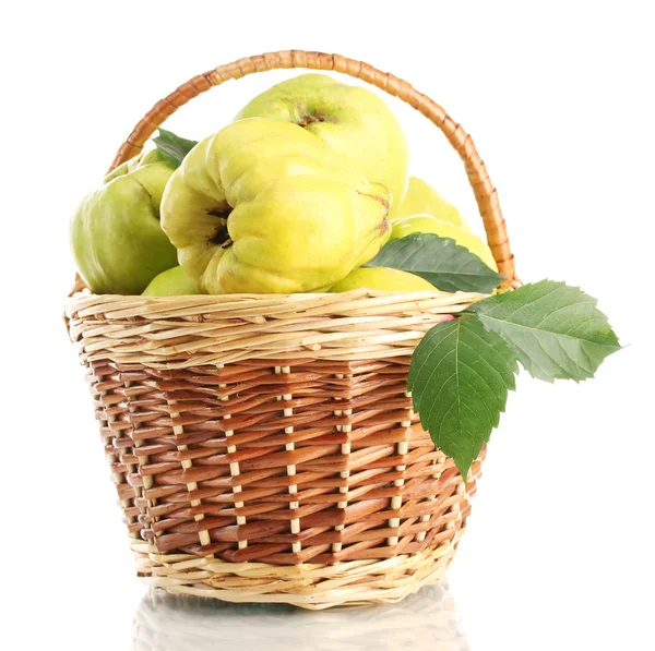 Sweet quinces with leaves in basket, isolated on white — Stock Photo, Image