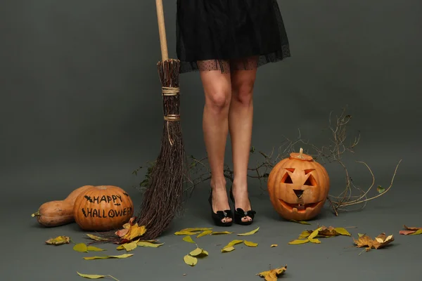 Halloween background with pretty female legs — Stock Photo, Image