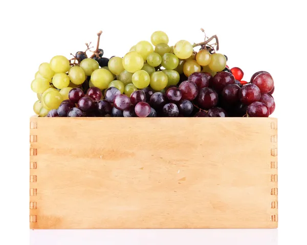 Assortment of ripe sweet grapes in wooden crate, isolated on white — Stock Photo, Image