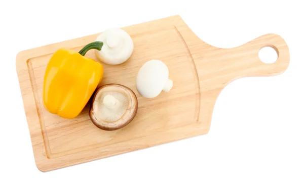 Paprika and mushrooms on wooden cutting board isolated on white — Stockfoto