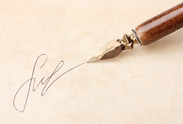 Closeup of signature (fake, not real) and ink pen, on old paper — Stock Photo, Image