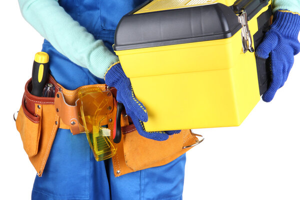Male builder in blue overalls with yellow suitcase isolated on white