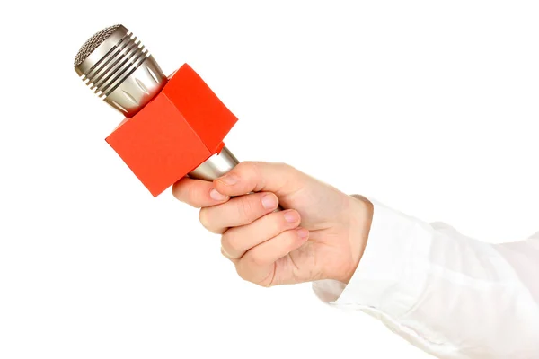 Mão feminina com microfone isolado em branco — Fotografia de Stock