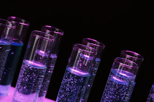 Test-tubes with liquid on black background — Stock Photo, Image