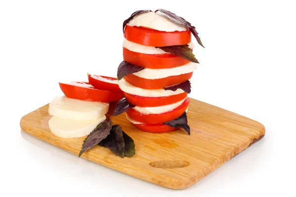 Tasty mozzarella with tomatoes on chopping board isolated on white — Stock Photo, Image