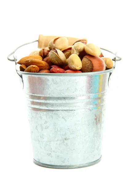 Assortment of tasty nuts in pail, isolated on white — Stock Photo, Image