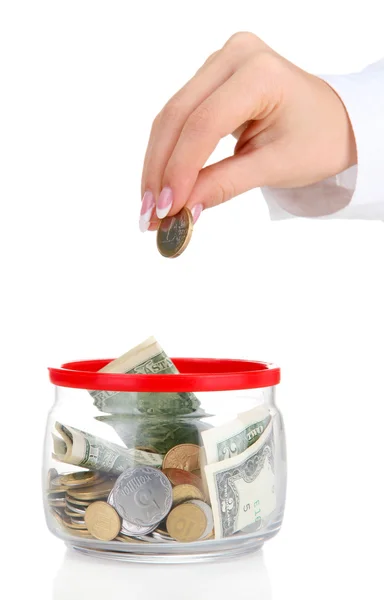 Frauenhand mit Geld in Glasgefäß isoliert auf weiß — Stockfoto