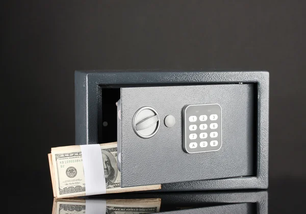 Money in open safe isolated on black — Stock Photo, Image