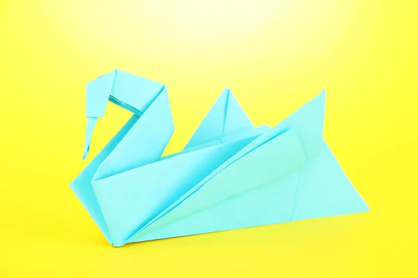 Origami swan on yellow background — Stock Photo, Image