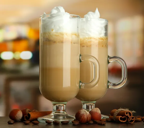 Caffè latte fragrante in tazze di occhiali con spezie, su tavolo in caffè — Foto Stock