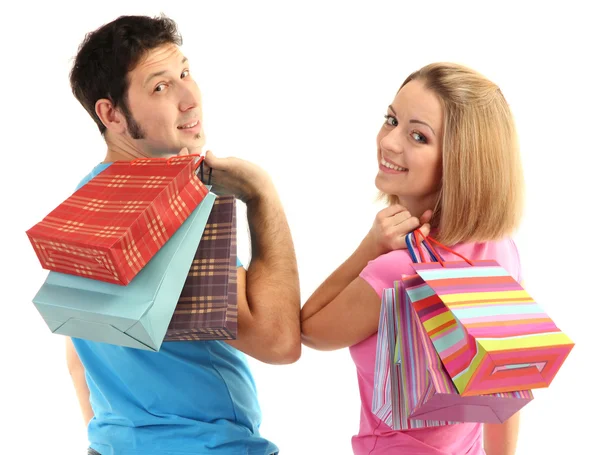 Jeune couple faisant du shopping et tenant de nombreux sacs isolés sur blanc — Photo