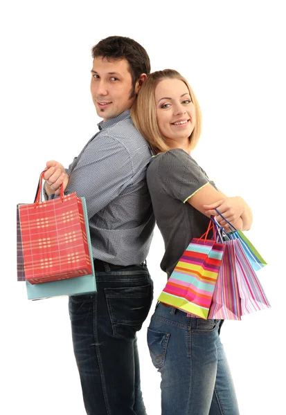 Casal jovem compras e segurando muitos sacos de compras isolados no branco — Fotografia de Stock