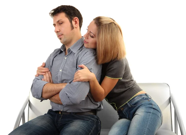 Young couple sitting together isolated on white — Stock Photo, Image