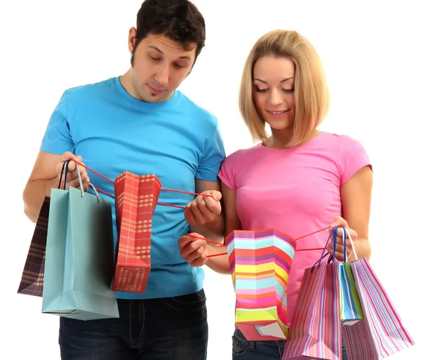 Young couple shopping and holding many shopping bags isolated on white Stock Photo
