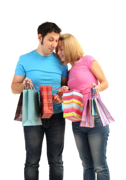 Young couple shopping and holding many shopping bags isolated on white Royalty Free Stock Photos
