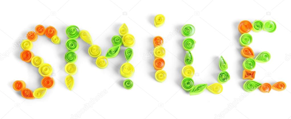 The word smile is made of quilling isolated on white