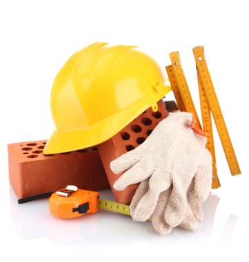 kask, rulet, tuğla ve üzerinde beyaz izole eldivenler