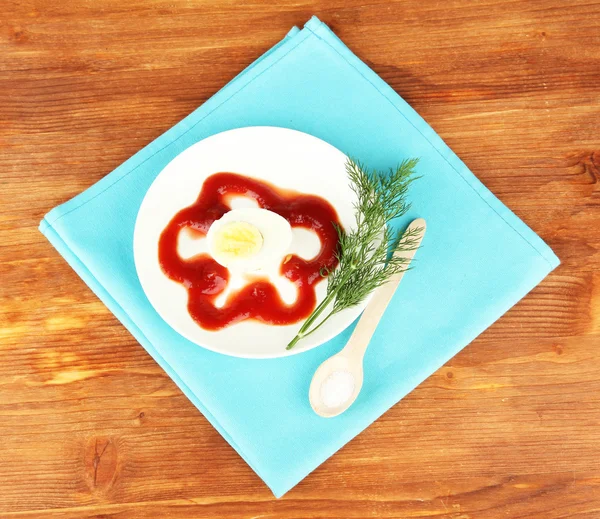 Варёное яйцо с кетчупом на деревянном фоне — стоковое фото