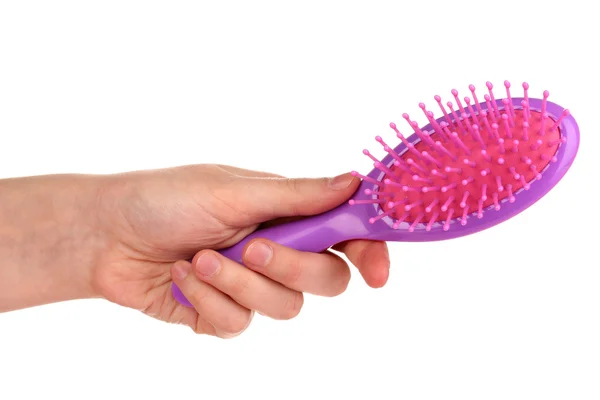 Spazzola per capelli viola nella mano isolata su bianco — Foto Stock