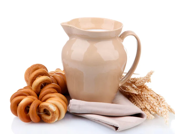 Jar of milk, tasty bagels and spikelets, isolated on white — Stock Photo, Image