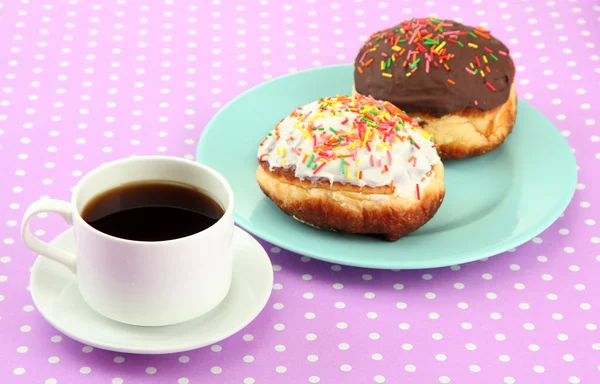 Tasty donuts on color plate on color background — Stock Photo, Image