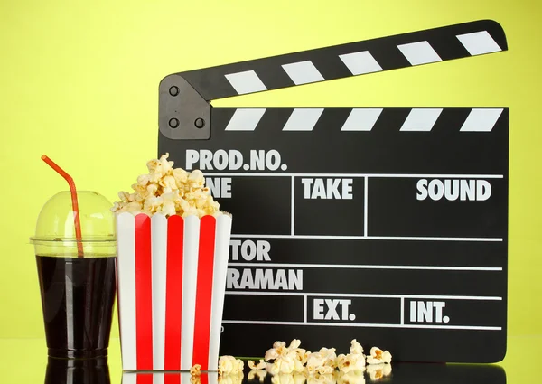 Film Filmklapper, cola en popcorn op achtergrond — Stockfoto