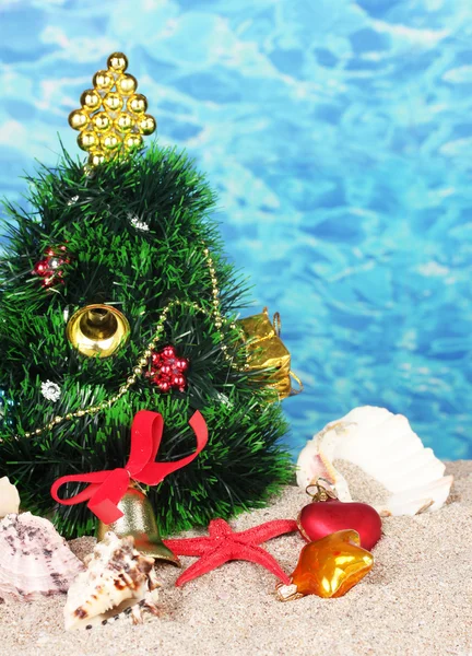 Christmas tree on sand in beach — Stock Photo, Image