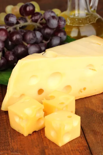 Сыр с виноградом на деревянном столе — стоковое фото