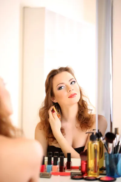 Portrait of attractive woman applying parfume — Stok fotoğraf