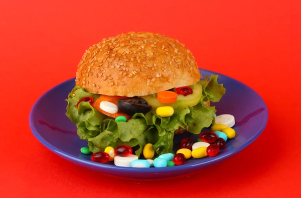Концептуальное изображение для ухода за питанием: разнообразные витамины и пищевые добавки в бун.На цветном фоне — стоковое фото
