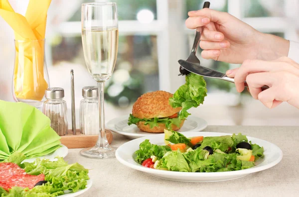 Female hand with dinner on bright background — Stock Photo, Image