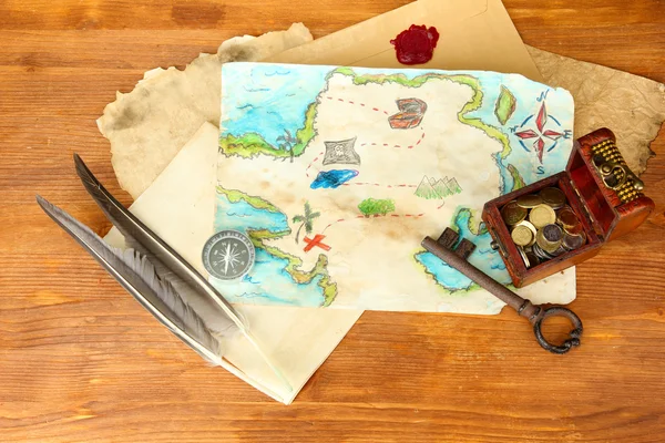 Map of treasures on wooden background — Stock Photo, Image