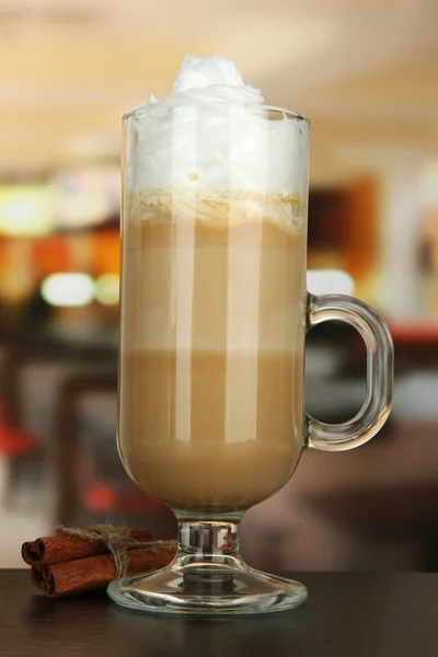 Caffè caffelatte profumato in tazza di vetro con baccelli di vaniglia, sul tavolo in caffè — Foto Stock