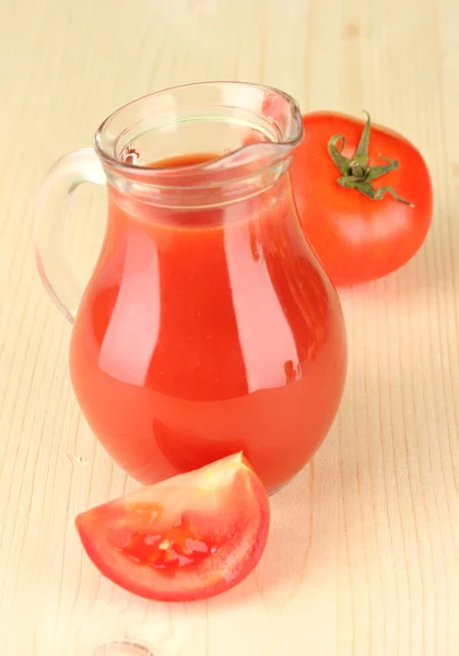 Full jug of tomato juice, on wooden background — Stock Photo, Image