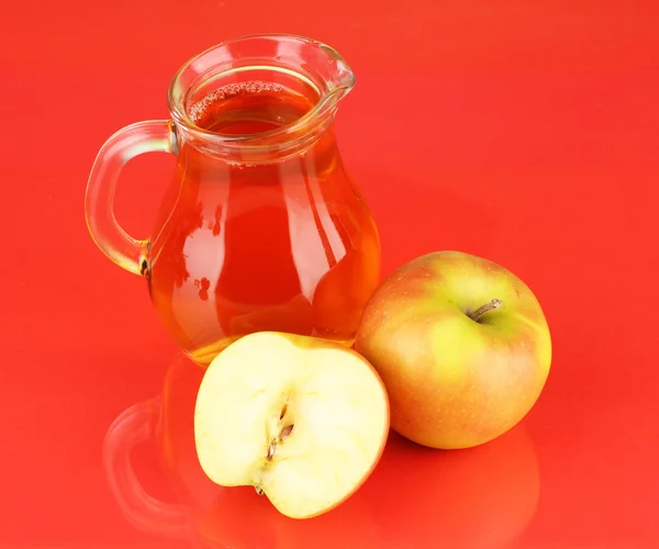 Plný džbán jablečné šťávy a apple na barvu pozadí — Stock fotografie