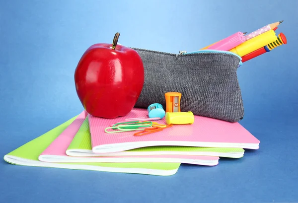 Pencil box with school equipment on blue background — Stock Photo, Image