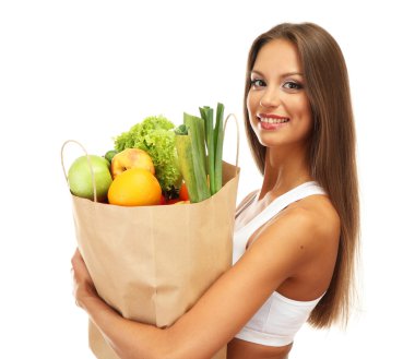 beautiful young woman with vegetables and fruits in shopping bag , isolated on white