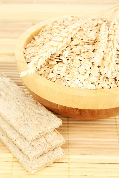 Wooden bowl full of oat flakes — Stock Photo, Image