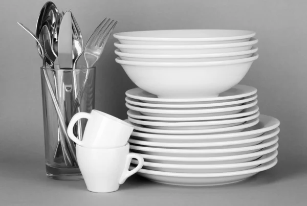 Clean white dishes on grey background — Stock Photo, Image