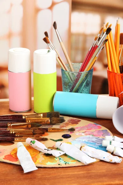 Artistic equipment: paint, brushes and art palette — Stock Photo, Image