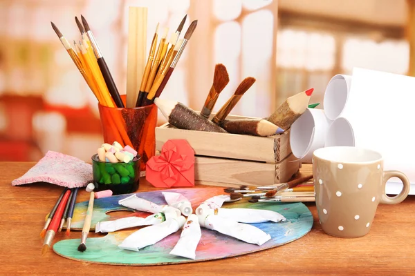 Artistic equipment: paint, brushes and art palette — Stock Photo, Image