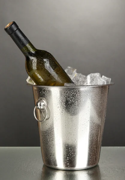Bottle of wine in ice bucket on black background — Stock Photo, Image