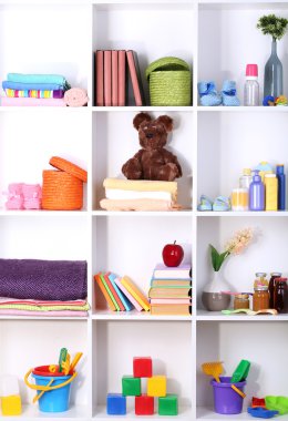 Beautiful white shelves with different baby related objects