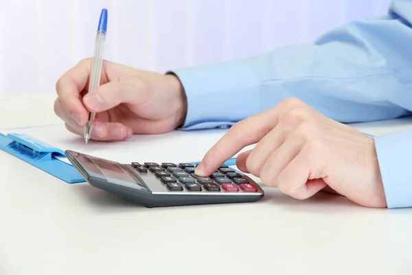 Closeup of businessman hands with calculator — Stock Photo, Image