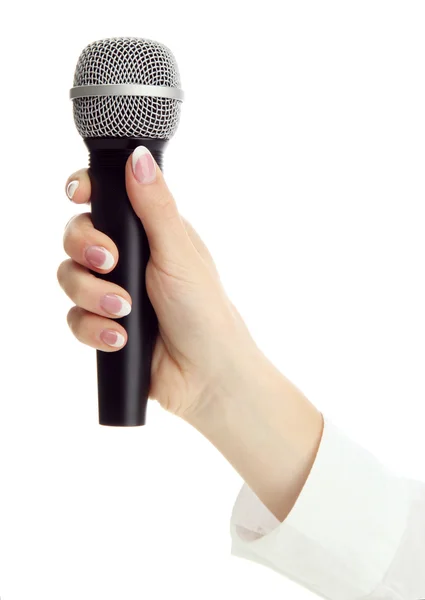 Main féminine avec microphone isolé sur blanc — Photo