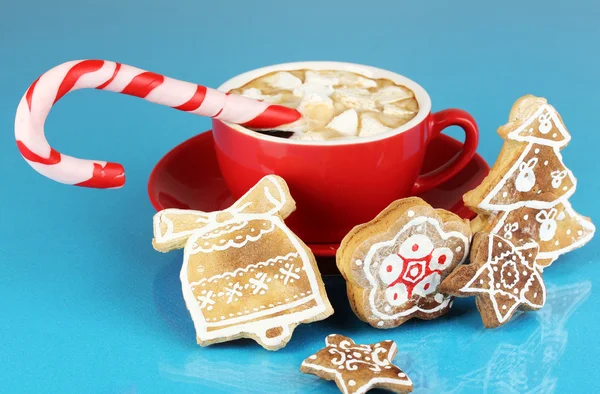 Cup of coffee with Christmas sweetness on blue background — Stock Photo, Image