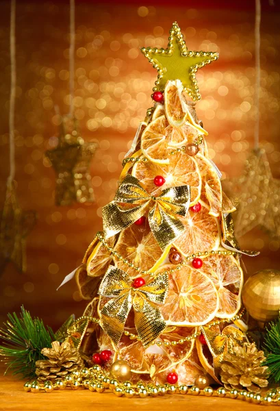 Bela árvore de Natal de limões secos com decoração, no fundo brilho — Fotografia de Stock