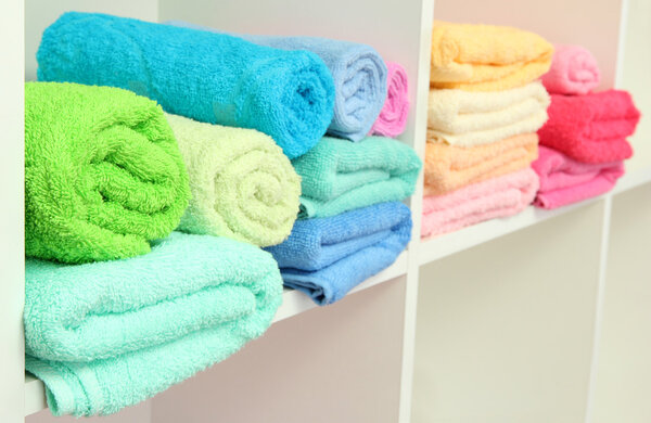 colorful towels on shelves in bathroom