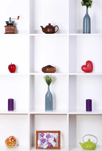 Beautiful white shelves with different home related objects — Stock Photo, Image